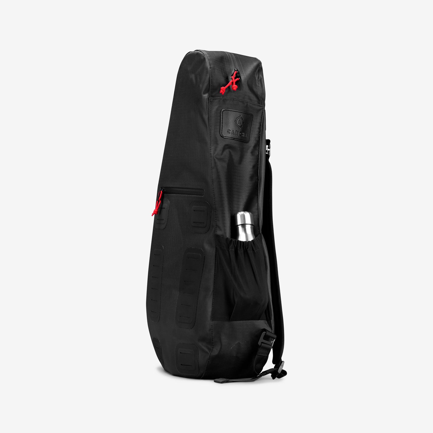 The Cancha Racquet Bag Voyager is a weatherproof black backpack with multiple compartments and distinctive red zippers, specifically designed for tennis travel, featuring an external pocket that includes a metal water bottle.