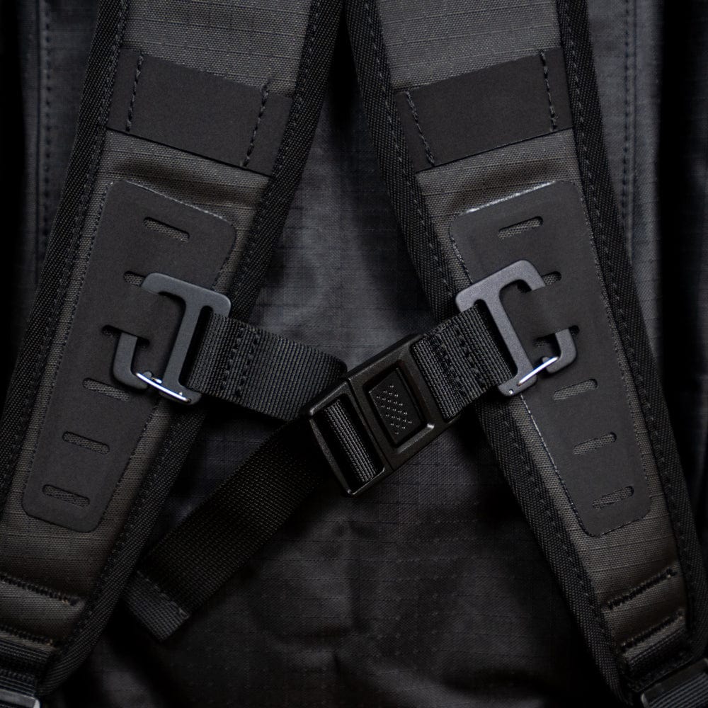 Close-up of the black adjustable straps and buckle system of the Original Racquet Bag (25L) by Cancha, made from lightweight, water-repellent materials.