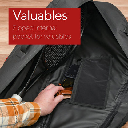 A hand places a phone into the zipped internal pocket of a Racquet Bag Voyager by Cancha, which is already holding tennis rackets. Text reads: "Valuables - Zipped internal pocket for valuables. Tennis travel made easy with weatherproof materials.”