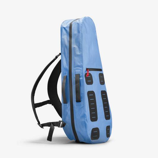 The Racquet Bag Voyager by Cancha is a blue, padded case featuring black shoulder straps and multiple black reinforced patches. It is designed for carrying and protecting your musical instrument, crafted from weatherproof materials.